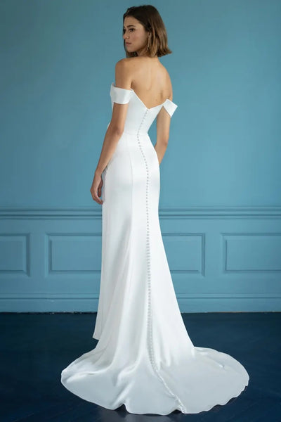 Elegant white Viviana - Jenny Yoo Wedding Dress gown with off-the-shoulder detailing and a trailing skirt from Bergamot Bridal.
