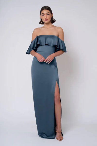 Woman posing in an elegant strapless neckline, Winter - Jenny Yoo Bridesmaid Dress by Bergamot Bridal evening gown with a thigh-high slit.