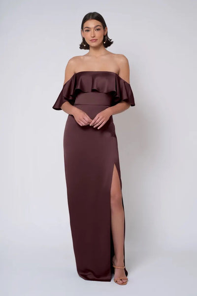 Woman in an elegant Winter - Jenny Yoo Bridesmaid Dress with a thigh-high slit from Bergamot Bridal.