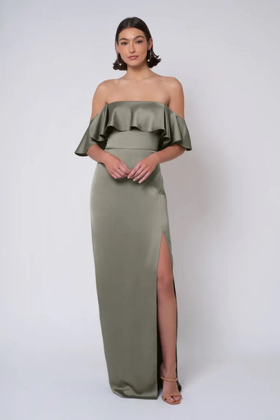 Woman in an elegant olive green Winter - Jenny Yoo Bridesmaid Dress with a strapless neckline, off-shoulder gown with a thigh-high slit from Bergamot Bridal.