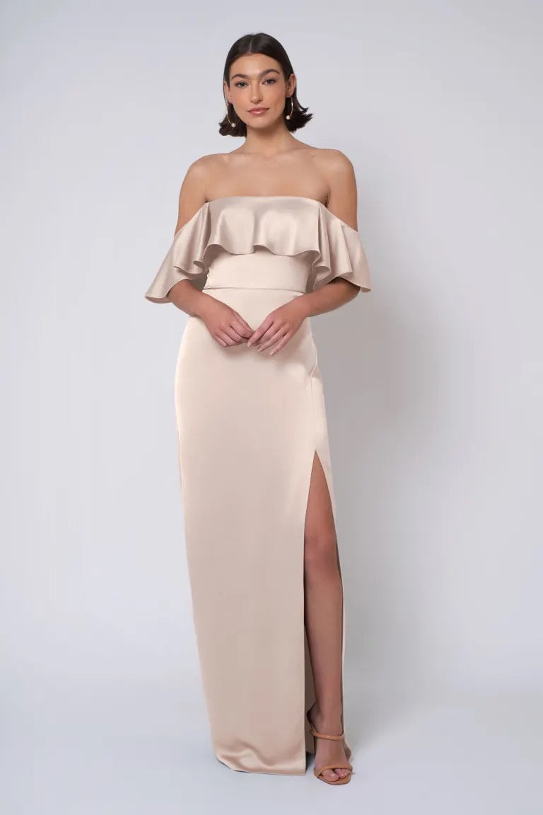 Woman posing in an elegant strapless neckline Winter - Jenny Yoo Bridesmaid Dress gown with a thigh-high slit by Bergamot Bridal.