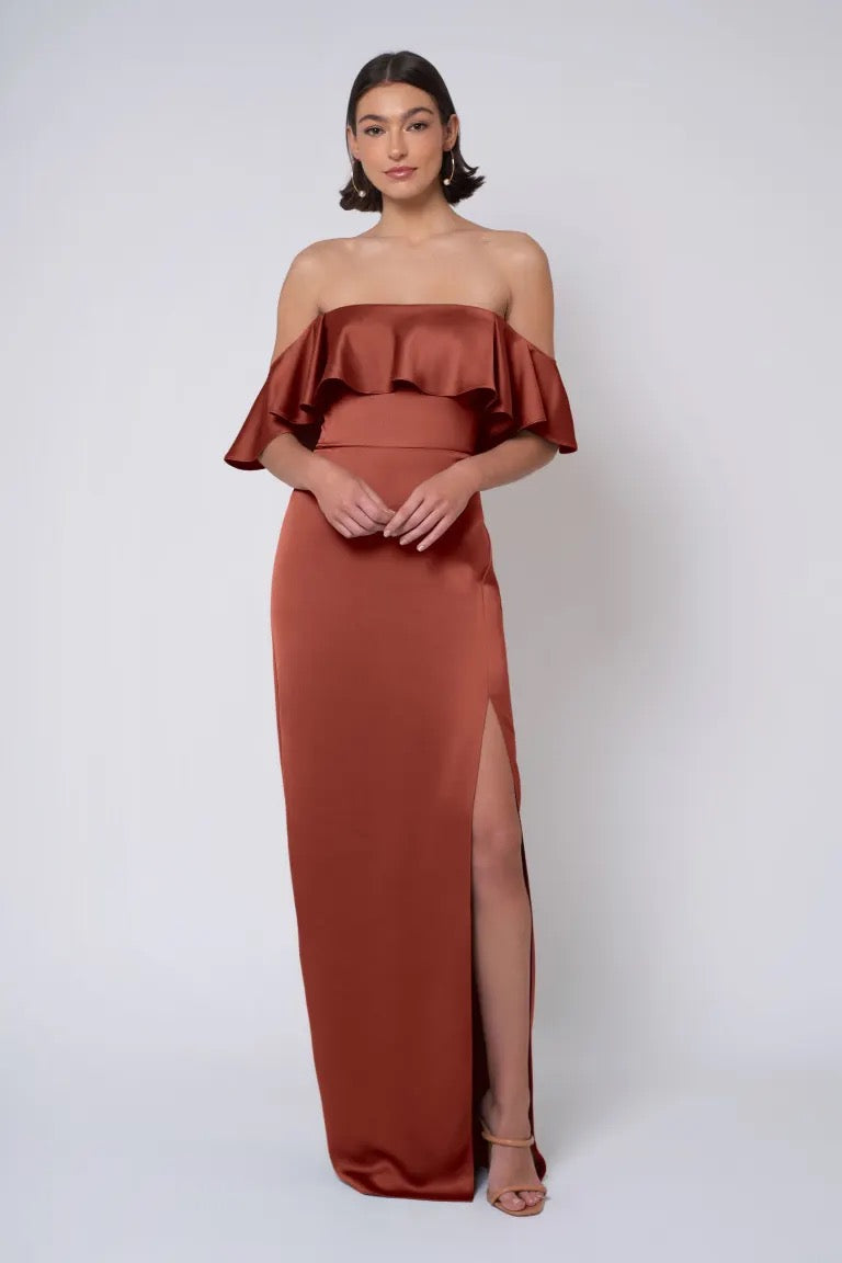 Woman in an elegant strapless neckline, terracotta evening gown with a high slit, Winter - Jenny Yoo Bridesmaid Dress from Bergamot Bridal.