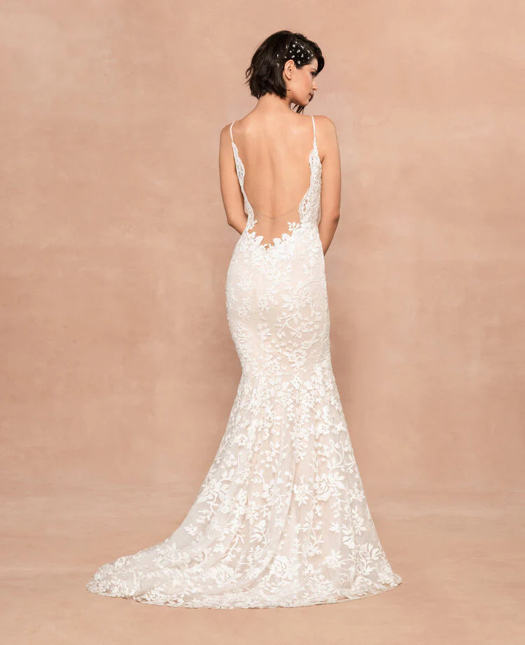 A woman in a Hayley Paige Havana Mermaid/Trumpet Wedding Gown with a sweetheart neckline and delicate floral sequined detail, standing against a neutral backdrop.