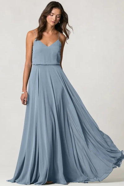 A woman in a flowing blue Inesse bridesmaid dress by Jenny Yoo from Bergamot Bridal.