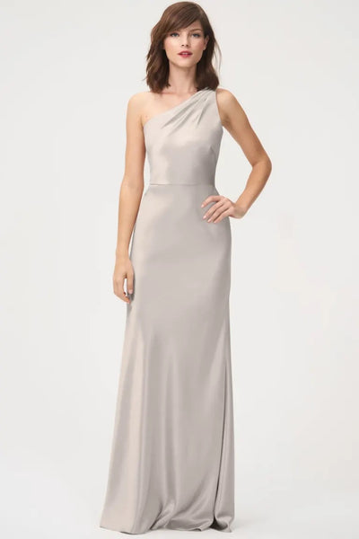 Woman posing in an elegant satin back crepe Lena Bridesmaid Dress by Jenny Yoo with a one-shoulder neckline from Bergamot Bridal.