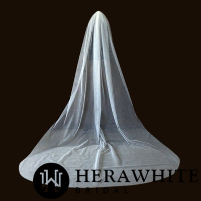 A wedding dress and Bergamot Bridal bridal veil on a mannequin against a neutral background, featuring the logo "herawhite bridal" at the bottom.