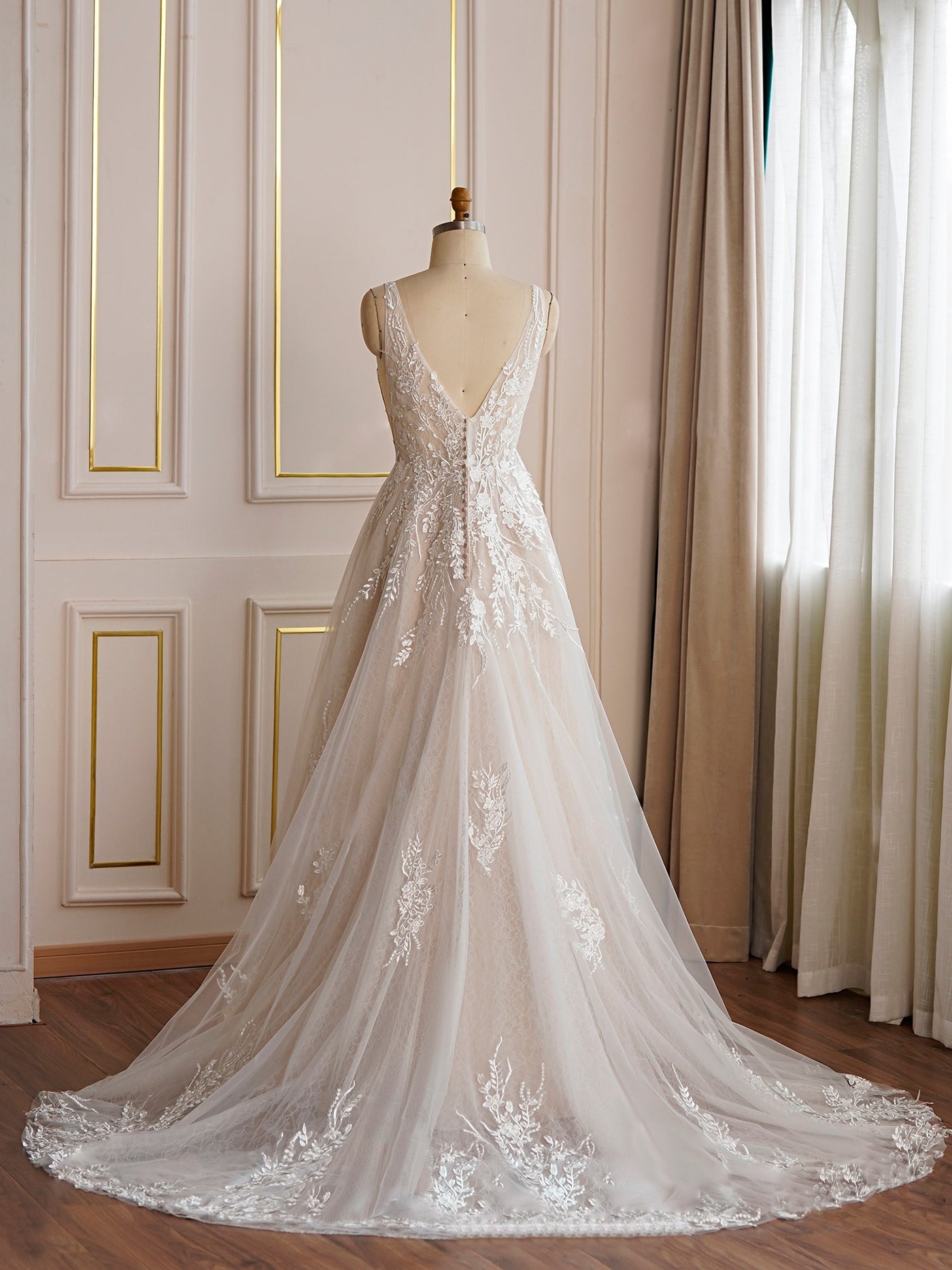 A V-neckline Floral Lace A-line Wedding Dress - Off The Rack by Bergamot Bridal in a bridal shop in London.