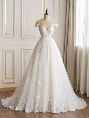 An Elegant Lace A-line Wedding Dress With Off the Shoulder Sleeves by Bergamot Bridal on a mannequin in a well-lit room.