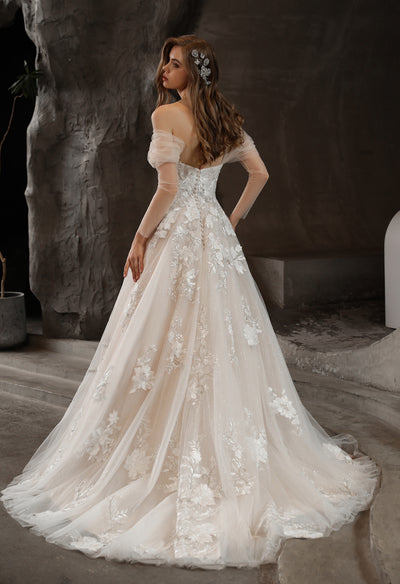 The back view of a woman in an Off-the-Shoulder Romantic Wedding Ball Gown with Glamorous Floral Motifs at Bergamot Bridal.