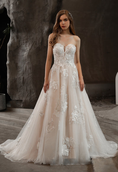 The bride is wearing an Off-the-Shoulder Romantic Wedding Ball Gown with Glamorous Floral Motifs from Bergamot Bridal, a bridal shop in London.