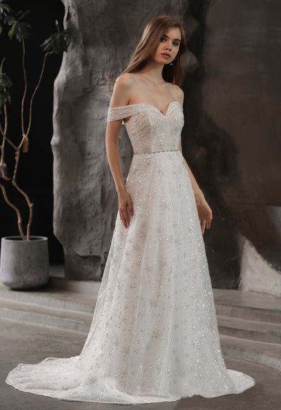 Off the shoulder Sparkly Beaded A-Line Bridal Gown With Off the Shoulder Sweetheart Neckline available at Bergamot Bridal in London.