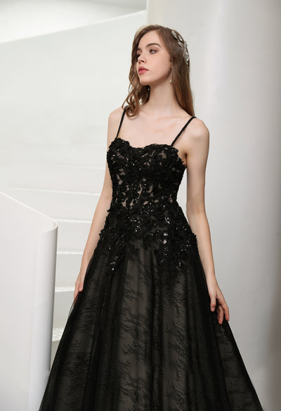A Black Illusion Lace Wedding Dress with Detachable Long Sleeves by Bergamot Bridal posing on a staircase.