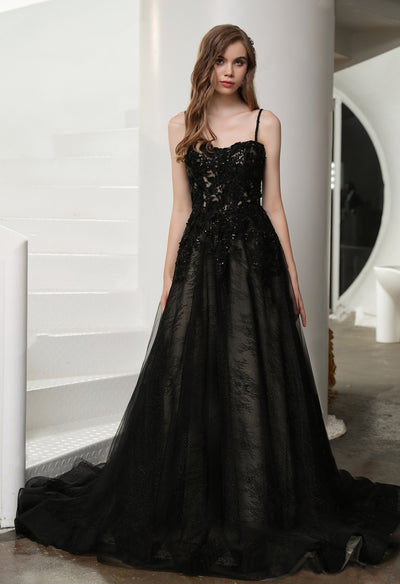 A woman in a Black Illusion Lace Wedding Dress with Detachable Long Sleeves, possibly a Bergamot Bridal gown, standing on the stairs.