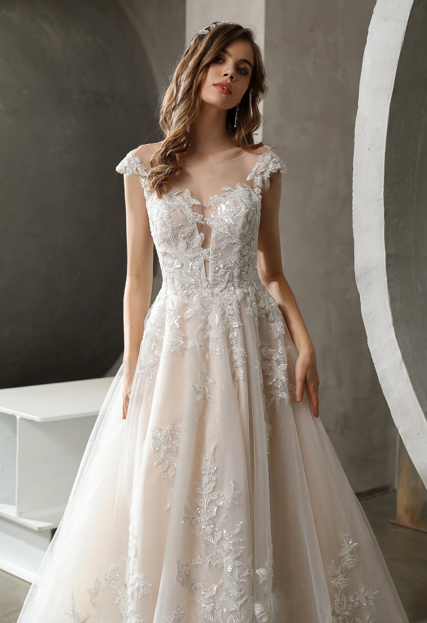 A beautiful Plunging Illusion Neckline with Beaded Lace A-line Wedding Dress available at Bergamot Bridal bridal shops in London.