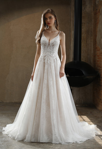A beautiful Beaded A-Line Wedding Dress with Spaghetti Straps and lace appliques available at Bergamot Bridal in London.