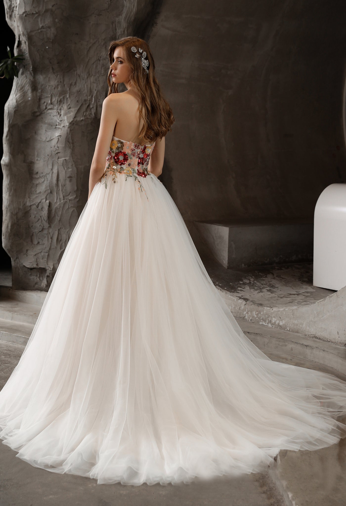 The back view of a woman in a Bergamot Bridal Strapless Princess A-line Bridal Gown with Tulle Skirt and Floral Beaded Bodice, at a bridal shop in London.