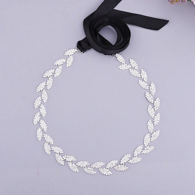 A Silver Leaf Crystal Bridal Belt Sash on a black ribbon is the perfect accessory for Bergamot Bridal shops.
