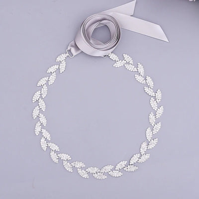 A Silver Leaf Crystal Bridal Belt Sash with a ribbon on it can be found at Bergamot Bridal shops.