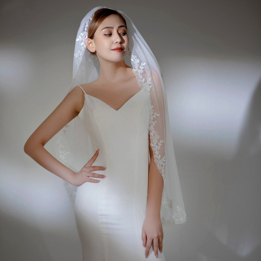 Embroidered lace edged fingertip length bridal veil