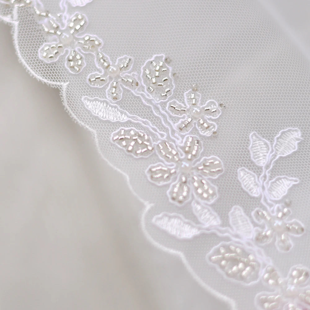 Embroidered lace edged fingertip length bridal veil