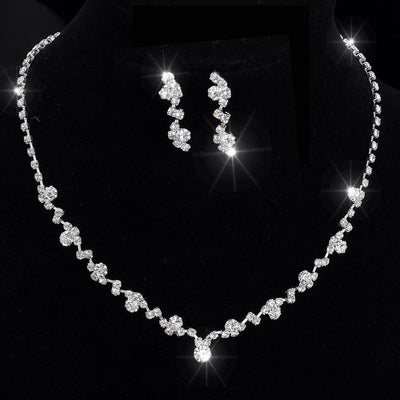 A Bergamot Bridal Crystal Necklace and Earring Set displayed on a black stand, sparkling under bright light in one of the bridal shops.
