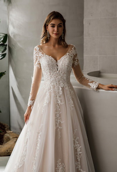 A beautiful Illusion Tattoo Lace Sleeve V-Neck A-Line Ballgown Bridal Gown available at Bergamot Bridal, a bridal shop in London.