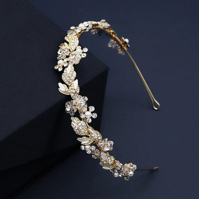 A Gold & Crystal Floral Hairband by Bergamot Bridal available at bridal shops.
