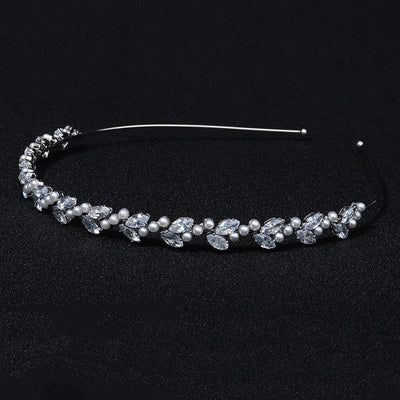 A Small Pearl & Crystal Headband by Bergamot Bridal can be found at bridal shops.
