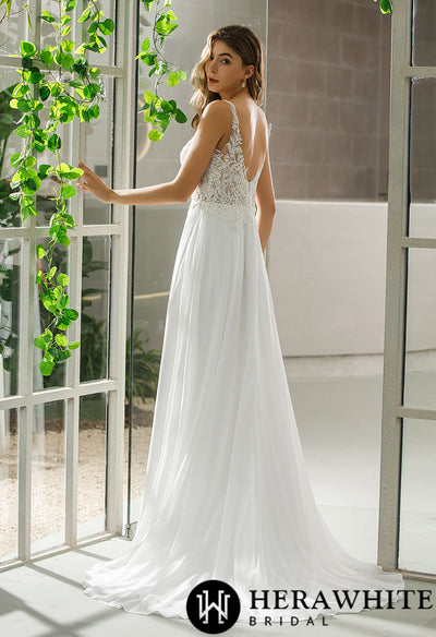 A bride wearing the "Illusion Bodice Chiffon Skirt A-Line Bridal Gown" by Bergamot Bridal in front of a window.