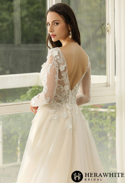 The back view of a woman in a Long Sleeve Ballgown Boho Bridal Gown from Bergamot Bridal.