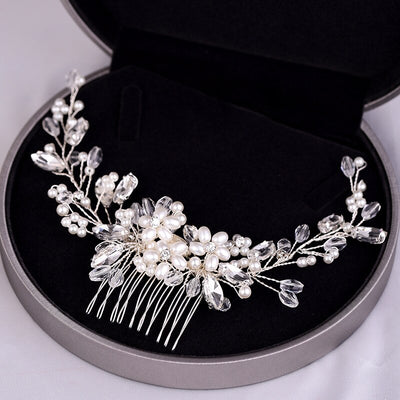 A Flower Crystal & Pearl Hair Comb by Bergamot Bridal in a black box can be found at bridal shops.
